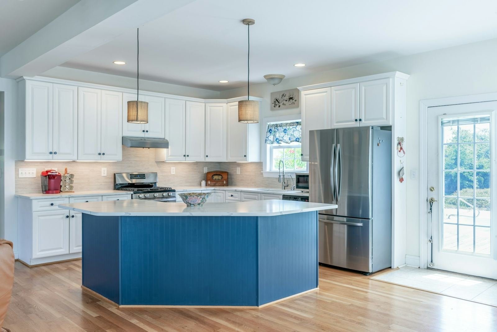 A white kitchen with a blue island