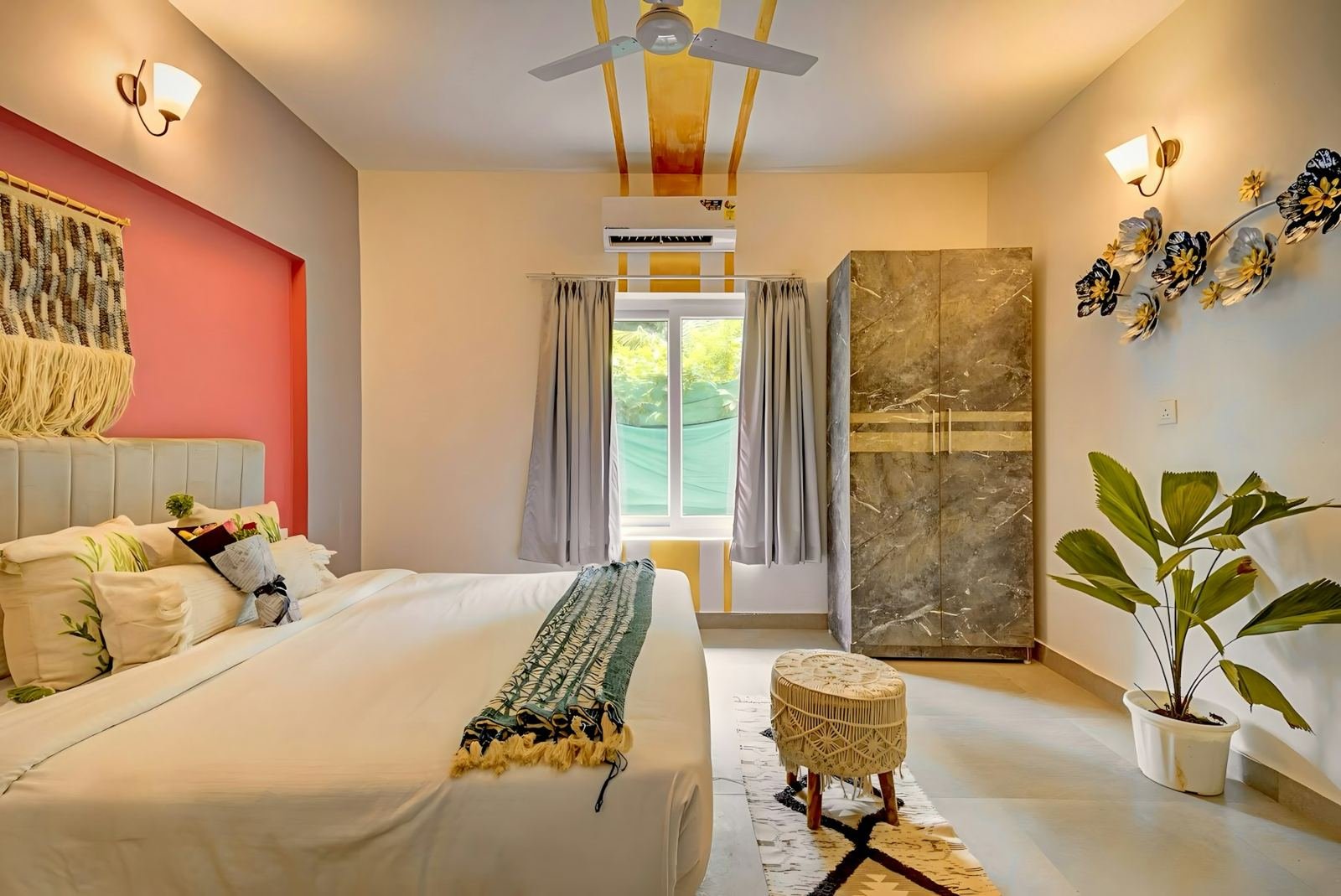 A bedroom with a coral-red feature wall