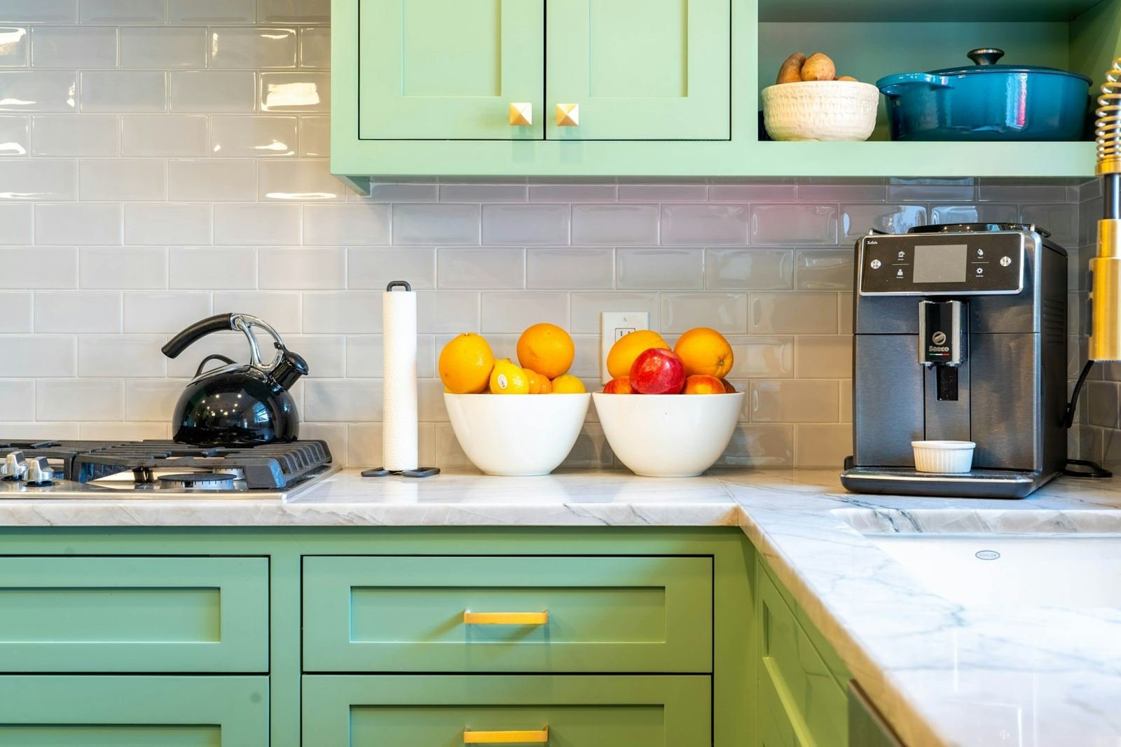 A kitchen with mint-green cabinets